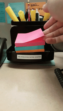 video of three different colors of sticky notes cascading down on one another